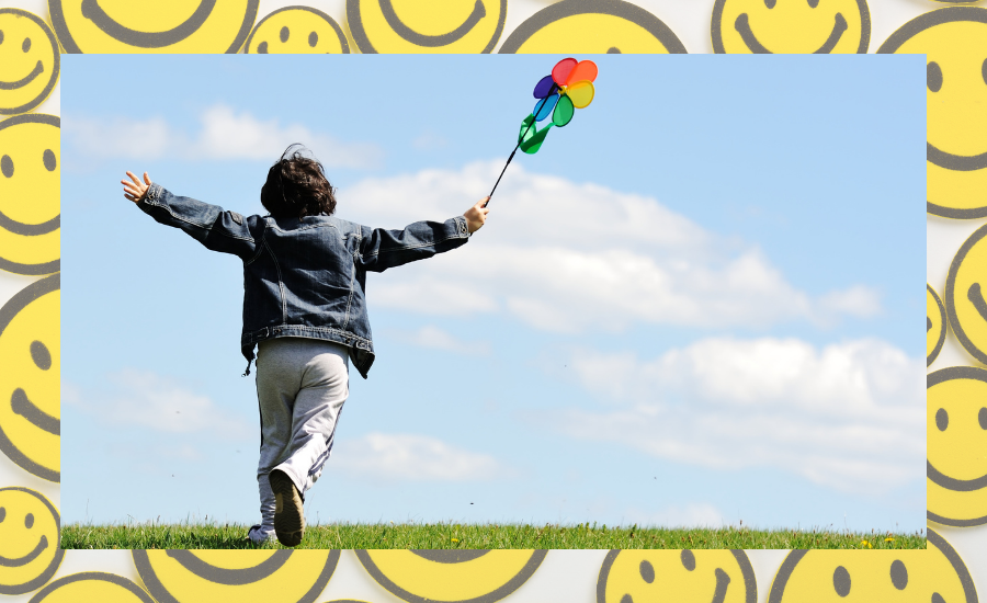 happy boy running with windmills